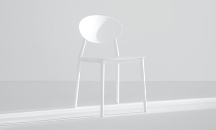 a very modern white chair